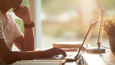 person on computer on desk