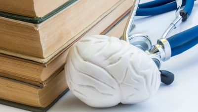 white brain with books and stethoscope